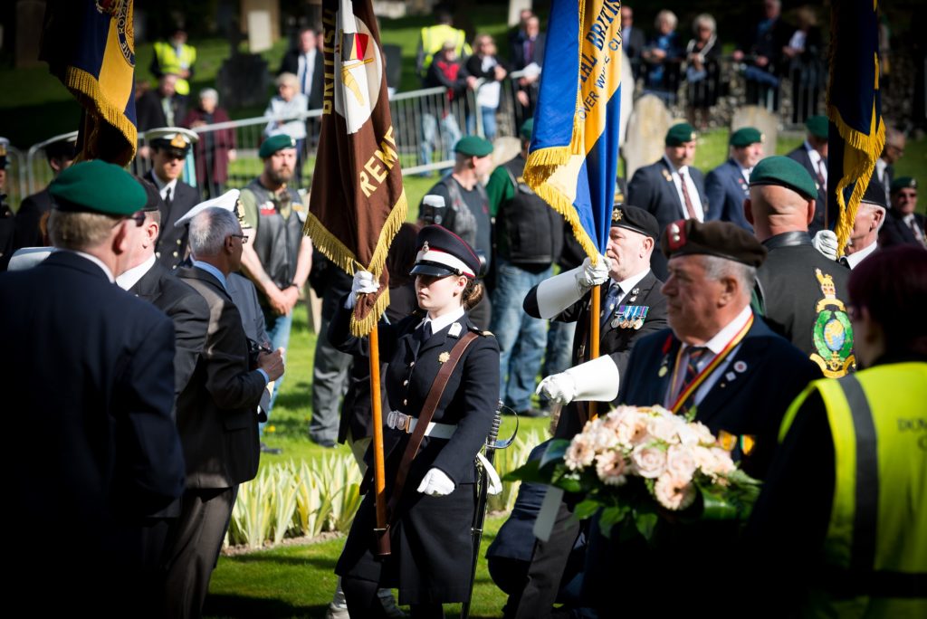 Student Niamh Proctor with ensign Duke of York’s Royal Military School honours Great War heroes